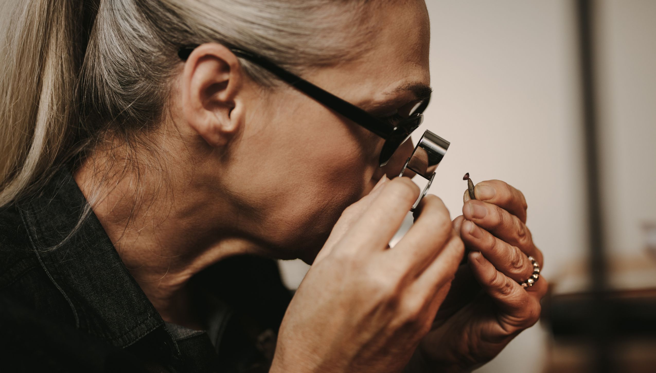 Detailed view of a master jeweler crafting a diamond ring